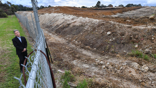 Curt Thompson stands at the boundary of a former quarry and rubbish dump in Oakleigh south.