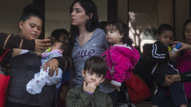 Central American migrant families wait to be taken to the McAllen bus station from the Catholic Charities Humanitarian Respite Centre, in McAllen, Texas. 