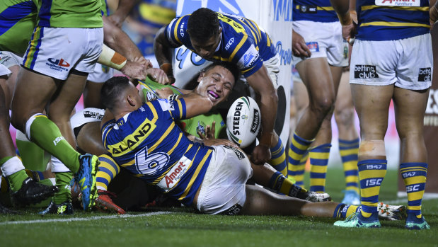 Sheer brawn: Joshua Papalii celebrates after muscling his way across the stripe.