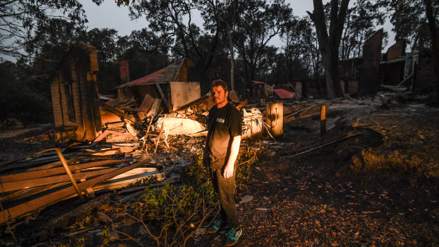 Russell Marriott in front of his burnt out home two days after the fire in Mallacoota.