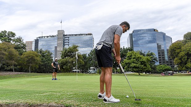 Hoping to sink a long putt on the Albert Park Golf Course.