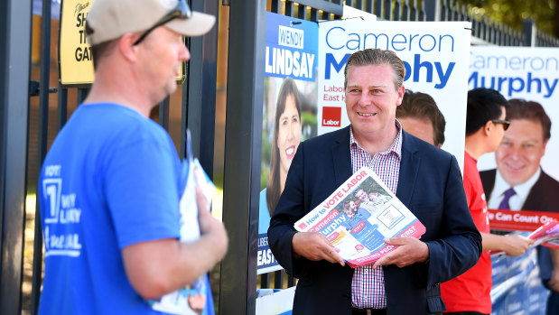 NSW Labor candidate for East Hills Cameron Murphy hands out flyers at Padstow Park Primary School on Saturday.