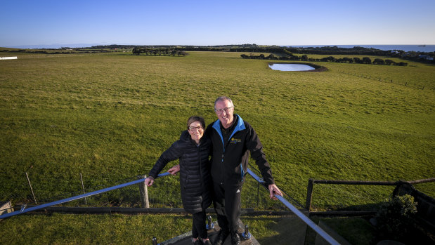 Land owners Karen Green and Robert Newall and, in the background, the farmland Matthew Guy briefly rezoned for housing.