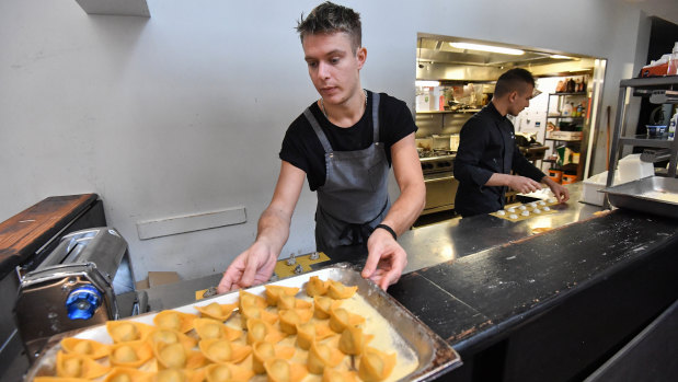 Chef Andrea Vignali prepares pasta at his new business.