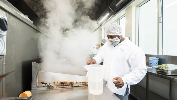 Chef Balraj Kumar preparing hot meals in the kitchen of airline caterer dnata's new Canberra facility.