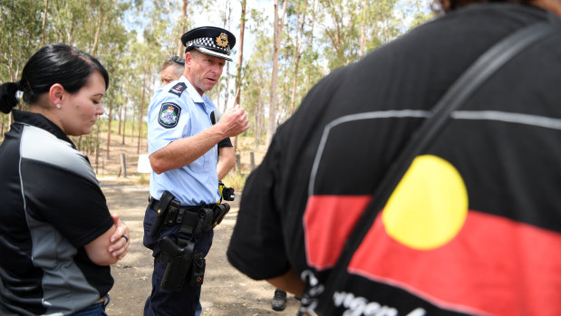 Queensland Police Acting Inspector Brett Wendt talks to protesters in Deebing Heights on Thursday.
