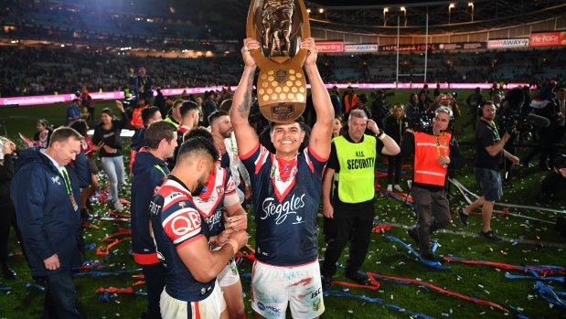 Starring role: Latrell Mitchell with the trophy after the Roosters' win over the Storm.