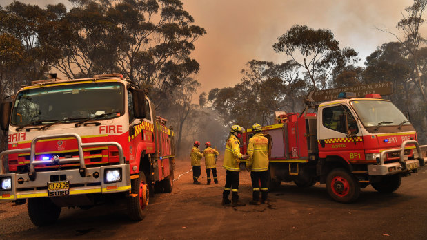 NSW Rural Fire Service and Fire and Rescue crews work on the Gospers Mountain fire on Tuesday.