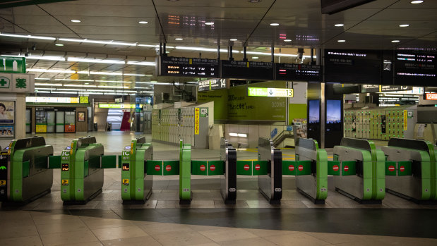 Shinjuku Station, usually one of the world's busiest railway stations, lies empty as all train services are suspended.