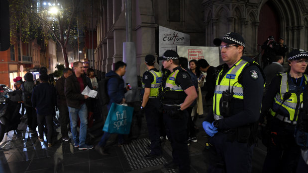 Police stand guard outside the event.