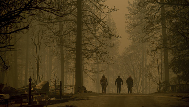 Sheriff's deputies search for human remains in a neighborhood destroyed by the Camp Fire.