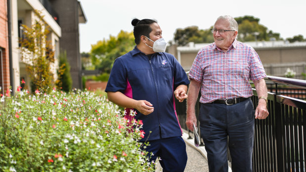 Aged care worker Joeben Roxas with resident Bernie Hasell. Joeben has moved into the aged care facility where he works.