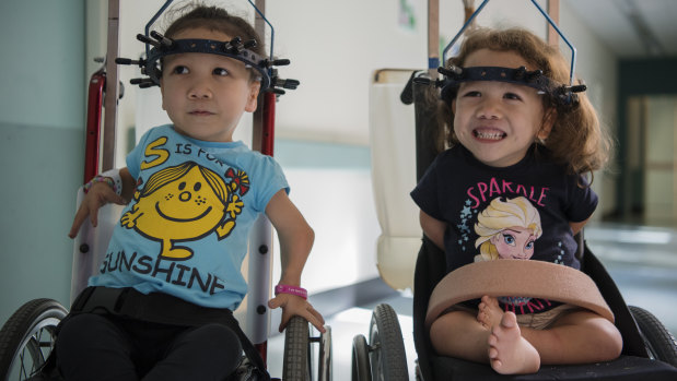 Metal halo devices, attached to Maddy and Briella's skulls with pins, will be weighted to gradually straighten their spines and prevent spinal cord damage and worsening respiratory problems.