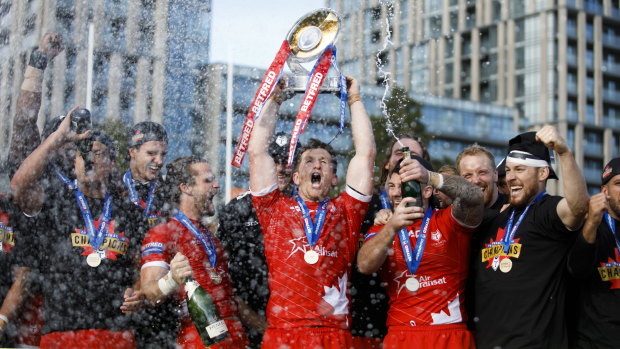 England-bound: Toronto Wolfpack captain Josh McCrone raises the trophy after defeating the Featherstone Rovers in the Million Pound Game in a Betfred Championship rugby league play-off game in Toronto on Saturday.