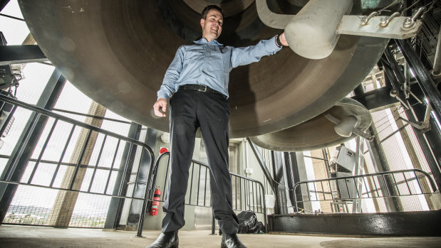 National Capital Estate executive director Lachlan Wood inspects the Carillon clappers before their replacement.