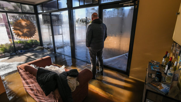 Rochester Motel owner Matt Keating watches the flood outside.