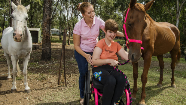 Georgia Groom, 15, with her mother  Kim Sindel at home with their horses Rusty and Ally.