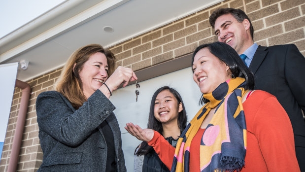 ACT Housing Minister Yvette Berry hands over the first keys to Christine Van and daughter Chloe ,15.