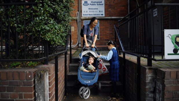 Linda Gu drops her daughter off at school on her first day back on Wednesday.