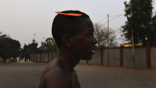 A soccer player at the end of a game on the streets.