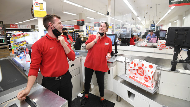 Coles workers Brad Wilkinson and Mia Belic removed their masks at 6pm Friday when mandatory face coverings were lifted. 