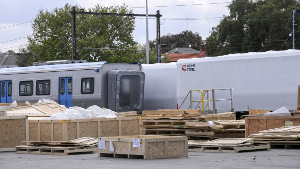 Rail carriages made in China sit in rail yards in Newport on Friday, awaiting assembly. Delivery of the first of 65 trains is running a year late.