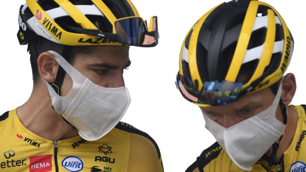 German Tony Martin, right, and Belgium's Wout Van Aert talk with masks on between stages.
