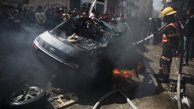 The wreckage of a vehicle following an Israeli air strike in Gaza City on Sunday.