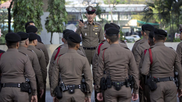 A police briefing outside a polling station before the start of voting in Bangkok on Sunday.