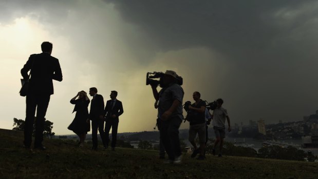 Transport Minister Andrew Constance holds a press conference at 12.30pm as storm clouds loom behind him. 