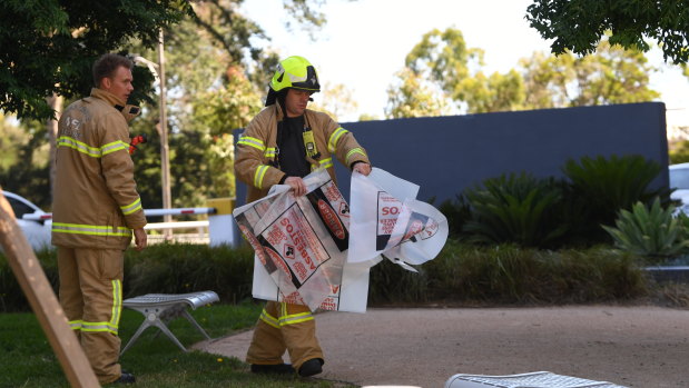 A firefighter is seen carrying a hazardous material bag into the South Korean consulate in Melbourne on Wednesday.