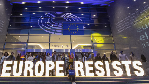 European citizens celebrate with illuminated letters on the steps of the European Parliaments as election results come in.