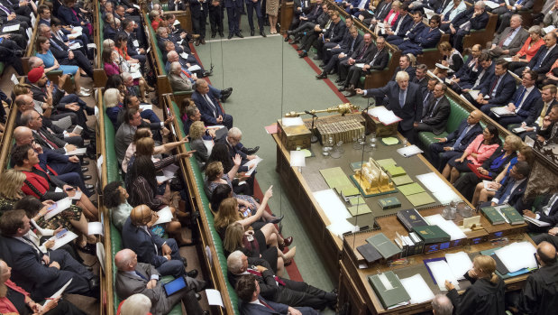 Britain's Prime Minister Boris Johnson, centre right, gestures during his first Prime Minister's Questions.