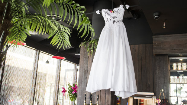Betti's trashed wedding dress now hangs over the bar at the Kingston Foreshore restaurant.