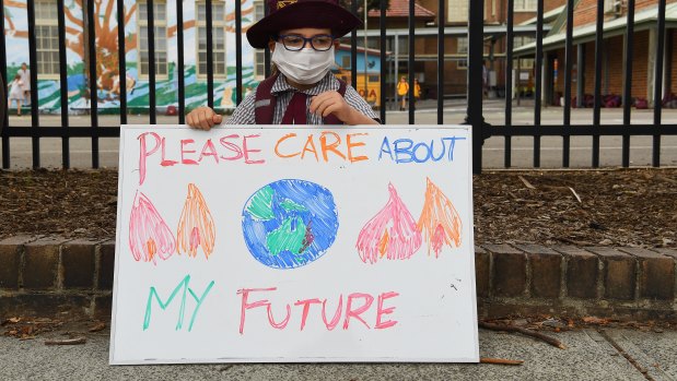 Scarlett Rigato, 5, holds a sign during a climate change protest by parents and students in Sydney last year.