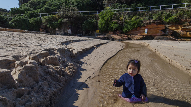 Anthem Mai, 1, playing where the storm water drain runs onto the north end of Coogee Beach.