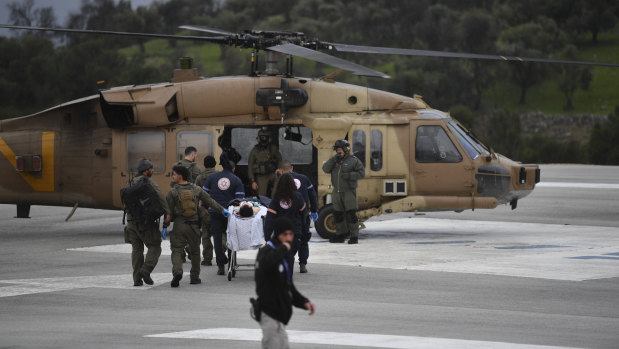 An Israeli medical team evacuate a person injured by a rocket fired from Lebanon, at Ziv hospital in Safed, northern Israel.