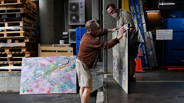 Paul Farrar wipes down his entries after being spattered by rain.