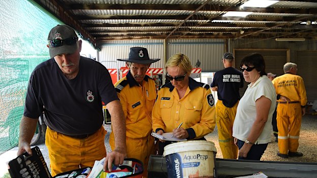 RFS Rainbow Flat firefighters replenish their medical kit at a temporary shed on a RFS member's property after the original shed was destroyed on November 8, 2019.