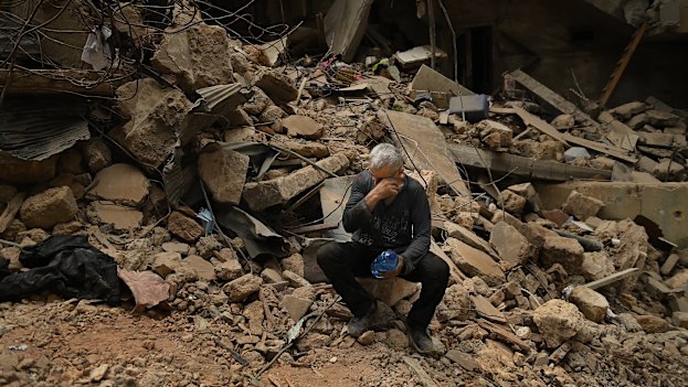 Salah, who witnessed the deadly Israeli airstrike, sits among the debris in Basta.