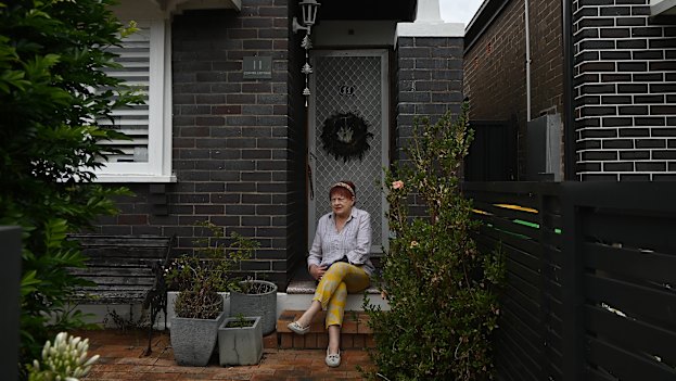 Caroline Gillham-Racz, 75, in front of her home in Campsie, where she has lived for 50 years. “They can take me out in a box,” she says.