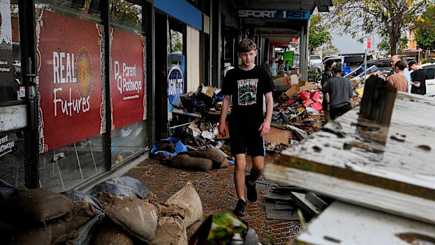 Locals start the clean-up on Manning Street in Taree.
