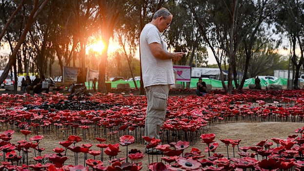On the first anniversary of the October 7 Hamas attack, a man stands among a memorial installation at the site of the Nova music festival where 324 people were killed on October 7, 2023.