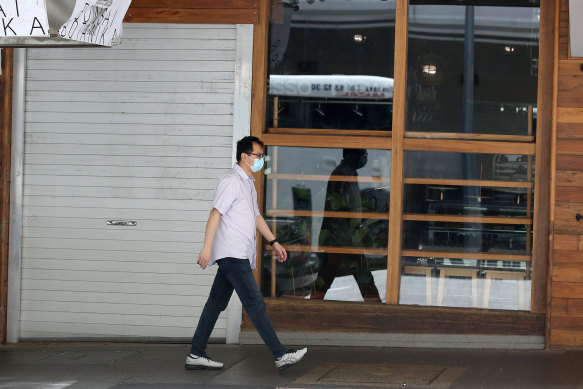 A man walks past a closed restaurant. Spending through the nation's restaurants has fallen 38 per cent on the same time last year, according to the Commonwealth Bank.
