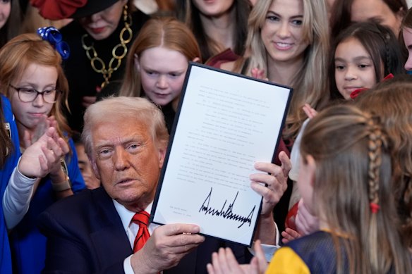 US President Donald Trump signs his executive order in February, barring transgender women from sporting events.