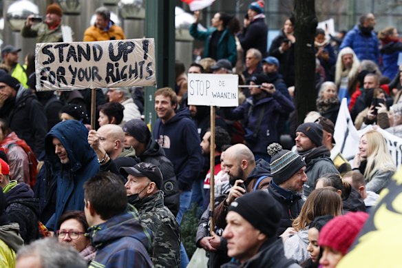 Crowds protest the latest measures by the Belgium government to counter the latest spike of the coronavirus in Brussels, Belgium. 