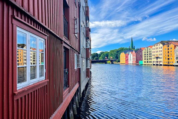 Old wooden buildings line the river leading to Trondheim’s famous cathedral.