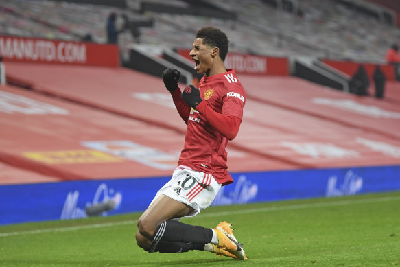 A jubilant Marcus Rashford celebrates his stoppage-time winner against Wolves at Old Trafford.