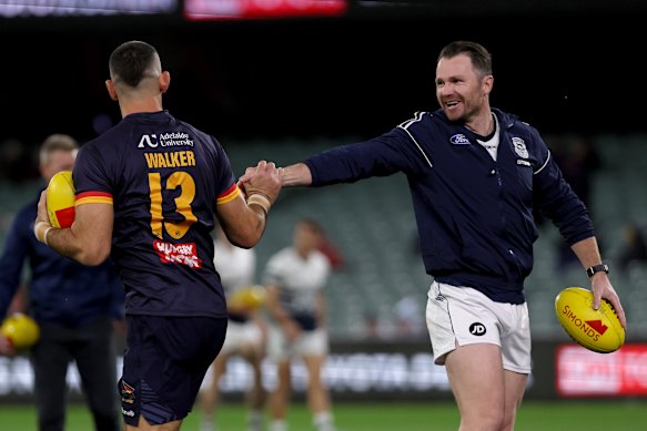Taylor Walker of the Crows and Patrick Dangerfield of the Cats warm up.