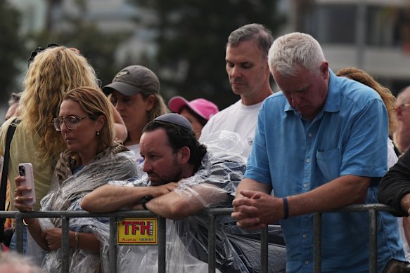 La gente participa en un minuto de silencio durante la ceremonia.